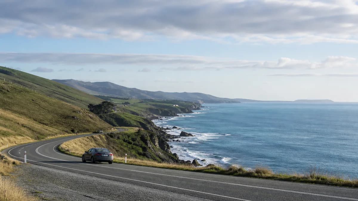 Rental car on a coastal Otago road near Dunedin