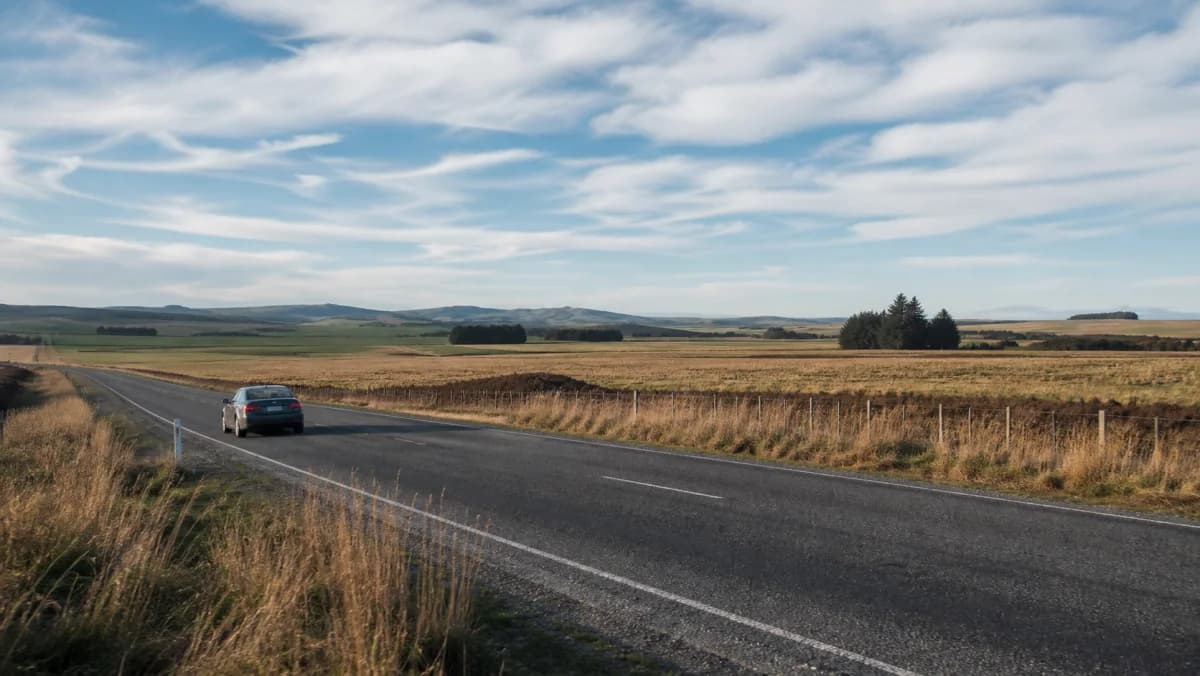 Rental car on an open Southland road near Invercargill