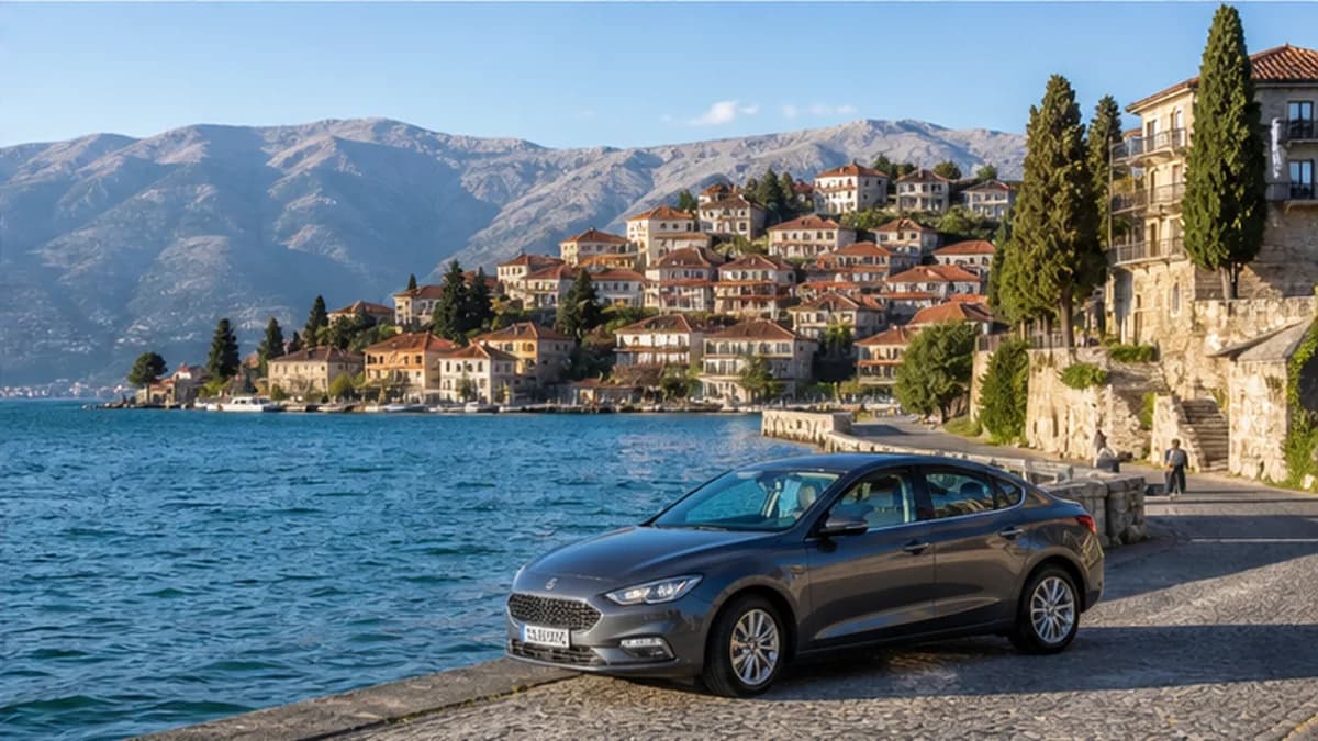 Rental car beside blue Lake Ohrid and mountains in North Macedonia