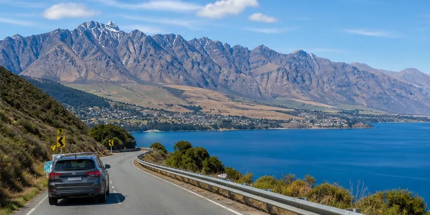 Rental car beside an alpine lake in New Zealand's South Island