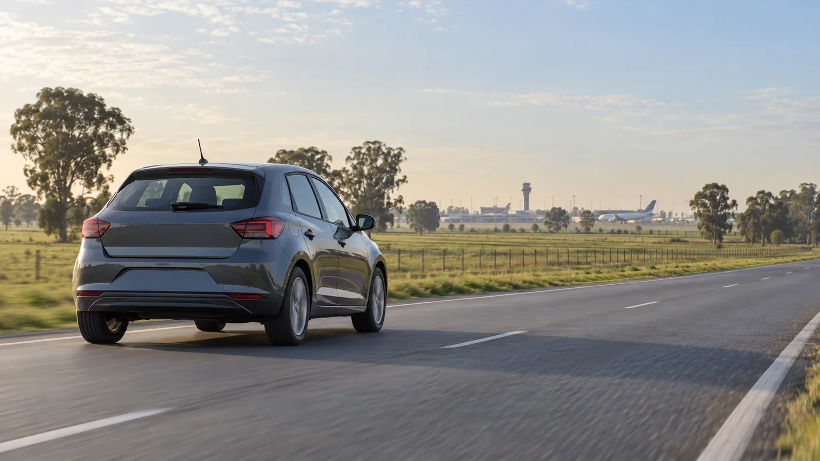 Ezeiza Airport car rental illustration showing an unbranded car on a green Buenos Aires approach road.